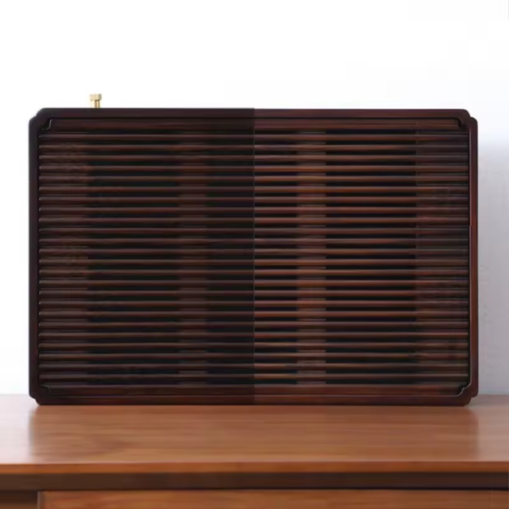 Large dark bamboo tea tray standing vertically on wooden sideboard