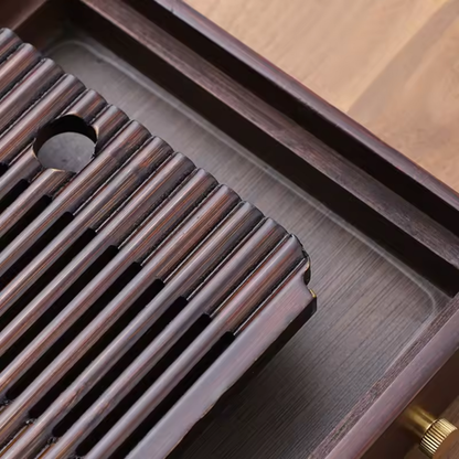 Close-up of removable slatted bamboo panel and hidden water tank under tea tray